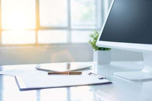 office desk with computer clipboard